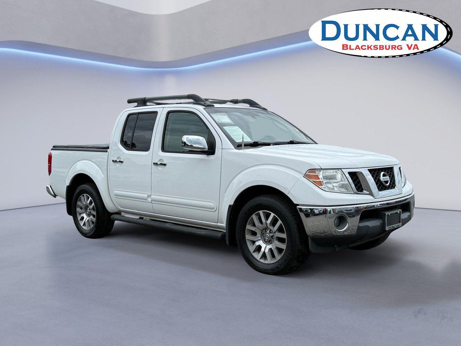 2011 Nissan Frontier SL in Avalanche — front three-quarter view